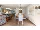 Dining area with a wooden table and chairs, hardwood floors, and natural light from a window at 2136 Kerwood Loop, The Villages, FL 32162