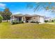 Charming single-story home featuring a well-manicured lawn, screened porch and an attached two-car garage at 2136 Kerwood Loop, The Villages, FL 32162