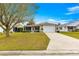 Well-kept single Gathering home with manicured lawn and a two-car garage at 2136 Kerwood Loop, The Villages, FL 32162