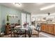 This kitchen has a dining area with a glass table and wrought iron chairs, along with light wood cabinets at 2136 Kerwood Loop, The Villages, FL 32162