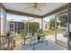 Relax on the screened lanai with comfortable seating and views of the well-maintained backyard at 2136 Kerwood Loop, The Villages, FL 32162