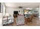 Inviting living room featuring wood flooring, a comfortable sofa, and an open layout to the kitchen at 2136 Kerwood Loop, The Villages, FL 32162