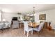 Open concept layout featuring the living room, dining area, and kitchen with hardwood floors throughout at 2136 Kerwood Loop, The Villages, FL 32162