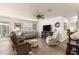 Bright living room with hardwood floors, a comfortable sofa, and a ceiling fan at 2136 Kerwood Loop, The Villages, FL 32162