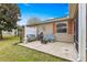 Cozy outdoor patio with seating and grill, perfect for relaxing and entertaining at 2136 Kerwood Loop, The Villages, FL 32162
