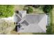 A high-angle aerial shot shows the roof and driveway of a home with a screened pool enclosure at 2185 Caxton Ave, Clermont, FL 34711