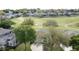 Aerial view of a home nestled in a neighborhood with lush green spaces and a winding golf course at 2185 Caxton Ave, Clermont, FL 34711