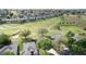 Community aerial view with houses, a golf course, and mature trees offering a serene and picturesque setting at 2185 Caxton Ave, Clermont, FL 34711