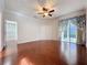 Primary bedroom featuring wood floors, crown molding, and slider to the screened lanai at 2185 Caxton Ave, Clermont, FL 34711