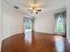 Spacious primary bedroom with hardwood floors, ensuite bath, and sliding door access to the lanai at 2185 Caxton Ave, Clermont, FL 34711