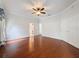 Primary bedroom featuring hardwood floors, ceiling fan, closet, and ensuite bath at 2185 Caxton Ave, Clermont, FL 34711
