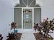 An inviting screened entryway welcomes visitors with verdant plantings at 2185 Caxton Ave, Clermont, FL 34711