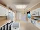 Bright kitchen features white cabinets, stainless steel appliances, and a breakfast nook at 2185 Caxton Ave, Clermont, FL 34711