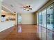 Open floorplan with hardwood floors leading into the kitchen and sliding doors to the lanai at 2185 Caxton Ave, Clermont, FL 34711