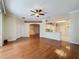 Open-concept living area with hardwood floors that connects seamlessly with the kitchen and dining spaces at 2185 Caxton Ave, Clermont, FL 34711