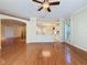 Open-concept living space flowing into the kitchen with hardwood floors and a ceiling fan at 2185 Caxton Ave, Clermont, FL 34711