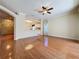 Open-concept living space with hardwood floors flowing into the kitchen with a ceiling fan at 2185 Caxton Ave, Clermont, FL 34711