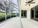 The screened lanai features a ceiling fan, views of golf course, and access to the living space at 2185 Caxton Ave, Clermont, FL 34711