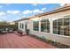 Private backyard patio featuring decorative potted plants and furniture with views of the manicured lawn and natural light at 2212 Bachman Path, The Villages, FL 32162