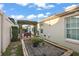 This lovely backyard boasts mature landscaping, a charming pergola, and a brick paver patio for outdoor enjoyment at 2212 Bachman Path, The Villages, FL 32162