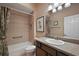Bathroom featuring a combination tub/shower, tiled walls, and vanity with a granite countertop at 2212 Bachman Path, The Villages, FL 32162