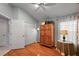 Inviting bedroom with hardwood floors, vaulted ceiling, and a large double door closet at 2212 Bachman Path, The Villages, FL 32162