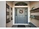 Charming entryway with a decorated front door, shelving, and a comfortable bench at 2212 Bachman Path, The Villages, FL 32162