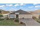 Inviting single Gathering home with a well-maintained lawn and attached two car garage at 2212 Bachman Path, The Villages, FL 32162