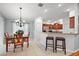 Kitchen and dining area with barstool seating; a great space for entertaining and casual meals at 2212 Bachman Path, The Villages, FL 32162
