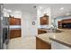 Spacious kitchen featuring granite countertops, tile floors, and ample cabinetry at 2212 Bachman Path, The Villages, FL 32162