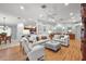 Spacious living room with neutral decor, hardwood floors, and recessed lighting, open to the kitchen and dining areas at 2212 Bachman Path, The Villages, FL 32162