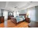 Serene main bedroom with hardwood floors, tray ceiling, and soft natural light, creating a relaxing retreat at 2212 Bachman Path, The Villages, FL 32162