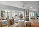 Cozy sitting area with large windows overlooking a private outdoor patio, hardwood floors, and natural light at 2212 Bachman Path, The Villages, FL 32162