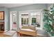 Cozy sunroom with large windows overlooking a private patio, offering ample natural light and comfortable seating at 2212 Bachman Path, The Villages, FL 32162