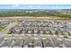 An aerial view shows a community with manicured lawns and harmonious architecture near green expanses at 2289 Mystic Maze Ln, Minneola, FL 34715