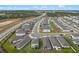 An aerial view showing a neighborhood with modern homes along a highway at 2289 Mystic Maze Ln, Minneola, FL 34715