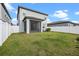 This home features a screened-in porch, a fenced yard, and nice green grass at 2289 Mystic Maze Ln, Minneola, FL 34715