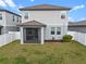 This home features a screened-in porch, a fenced yard, and nice green grass at 2289 Mystic Maze Ln, Minneola, FL 34715