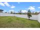 The backyard features a well-maintained lawn and a white fence, offering privacy and space for outdoor activities at 2289 Mystic Maze Ln, Minneola, FL 34715