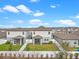 A view of the backyard features a lawn, white fences, and screened in patios on these beautiful homes at 2289 Mystic Maze Ln, Minneola, FL 34715