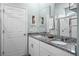 Modern bathroom with a double sink vanity, granite countertop, and a glass-enclosed shower at 2289 Mystic Maze Ln, Minneola, FL 34715