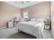 Bedroom showcasing a bed with white linens, neutral walls, and a workstation for added functionality at 2289 Mystic Maze Ln, Minneola, FL 34715