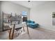 Bright bedroom with a glass desk, shelving, and comfortable lounge chair at 2289 Mystic Maze Ln, Minneola, FL 34715