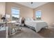 Comfortable bedroom featuring two large windows, a ceiling fan, and a cozy bed with white linens at 2289 Mystic Maze Ln, Minneola, FL 34715