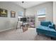 Cozy bedroom with ample natural light, furnished with a desk, shelving, and a lounge chair at 2289 Mystic Maze Ln, Minneola, FL 34715