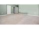 Spacious bonus room with plush carpet, three door openings, neutral colored walls, and base trim at 2289 Mystic Maze Ln, Minneola, FL 34715