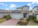 Attractive two-story home with a brick driveway and lush landscaping at 2289 Mystic Maze Ln, Minneola, FL 34715