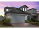 Charming two-story home featuring a brick driveway and well-manicured landscaping at 2289 Mystic Maze Ln, Minneola, FL 34715