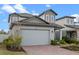Charming two-story home featuring a brick driveway and well-manicured landscaping at 2289 Mystic Maze Ln, Minneola, FL 34715