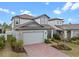 Well-maintained two-story home featuring a brick driveway and neat landscaping at 2289 Mystic Maze Ln, Minneola, FL 34715